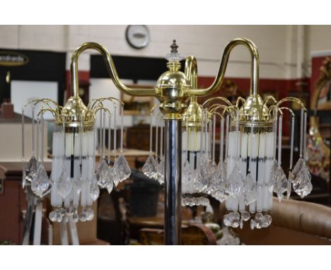 A contemporary gilt metal three branch standard lamp with pendant droppers.