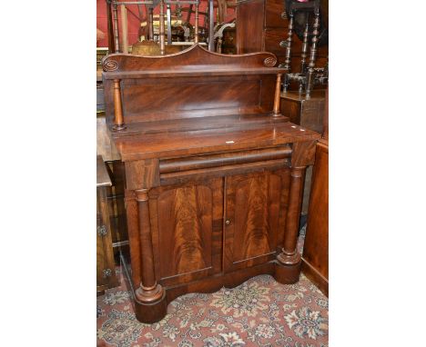 A William IV flame mahogany chiffonier, shaped pediment and shelf , tapering cylindrical supports, long drawer over two door 