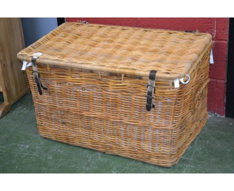 A large lined wicker hamper/log box