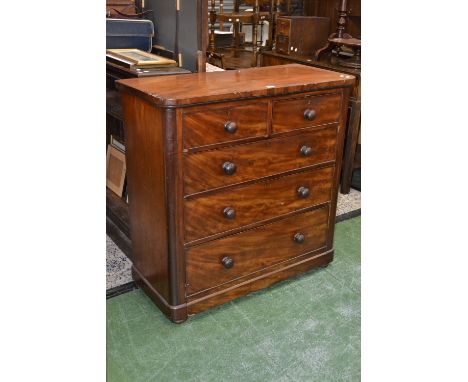 A Victorian mahogany chest, oversailing top, two short cockbeaded drawers over three graduated long, button handles, plinth b