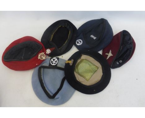 Seven British Army berets with badges including the Parachute Regiment, Royal Military Police, Army Air Corps, etc.