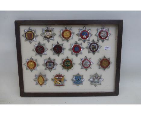 A framed display of 18 fire brigade chrome and enamel cap badges, average size approximately 1 3/4 x 1 3/4". All retain their