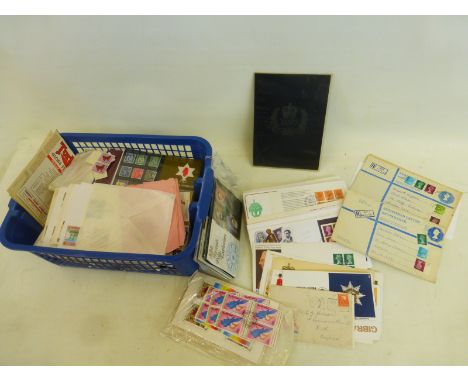 A basket of first day covers, postmarks, mint stamps, etc.