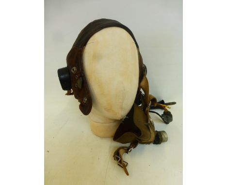 A WWII period leather airman's helmet with ear pieces and mouthpiece.