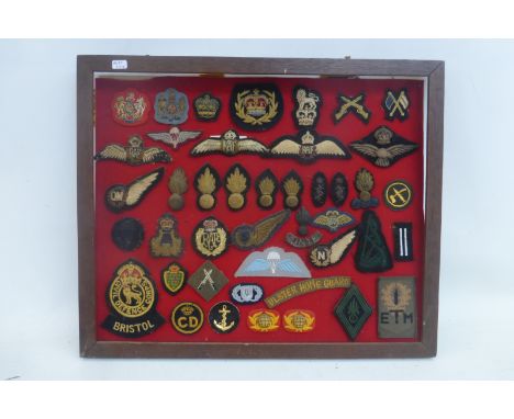 A framed display of 44 Royal Air Force and British Army bullion wire and embroidered cloth badges.