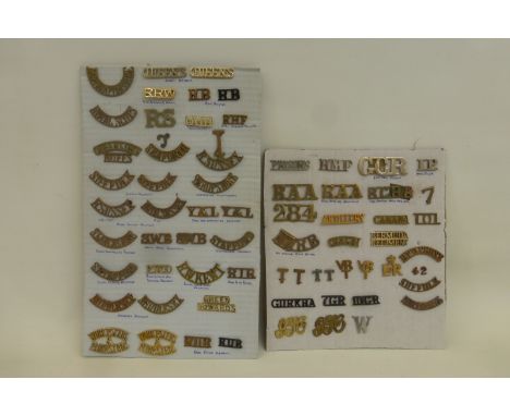Two display cards of in excess of 60 brass and staybrite shoulder titles including Ghurkha, 7GR, 10GR, Suffolk, S. Stafford, 