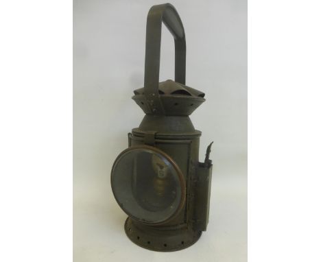 A railway lantern (painted drab green) possibly military, approximately 13 3/8" high.