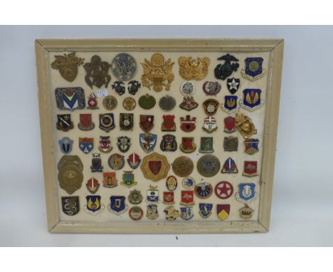 A framed display of 73 mainly enamel U.S. Army Air Force badges. All appear to retain their fixings to the reverse.