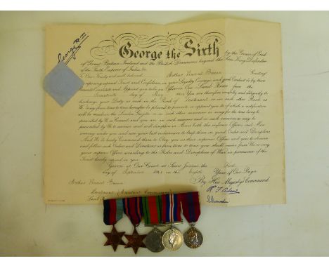 A WWII mounted medal group including the Burma Star and a QE2 Coronation Medal with a Promotion Warrant awarded to Lieutenant