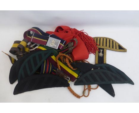 Four British Army stable belts and a sash, a small quantity of military bandsman's shoulder wings and lanyards.