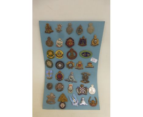 A display card of 33 sweetheart brooches and lapel badges including Wiltshire Regiment, Home Guard, Royal Marines, R.A.A., Ro
