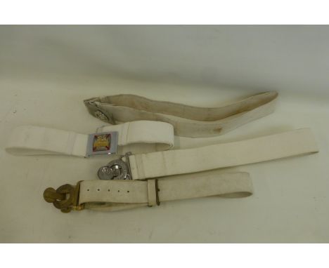 A Military Post 1953 heavy white plastic belt with brass buckle together with three military belts with buckles to the Royal 