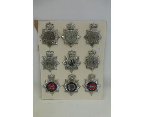A display of nine police and constabulary helmet badges, average size approximately 4 3/4 x 3 1/2". All retain their fixings 
