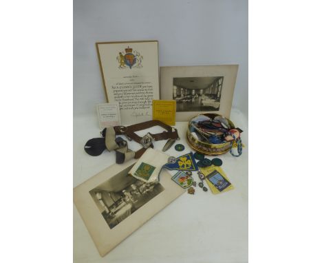 An assortment of 1950s and later Girl Guide memorabilia, including a belt with whistle and guide knife, enamel and cloth badg
