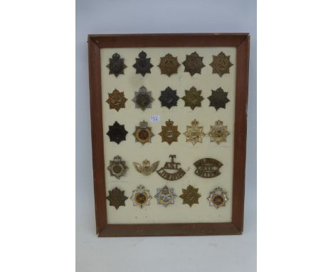 A framed display of 24 mainly Army Service Corps and Royal Army Service Corps badges and titles. All appear to retain their f