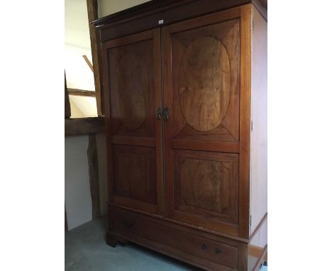Edwardian mahogany wardrobe with twin inlaid doors enclosing hanging space, above a single drawer, on bracket feet