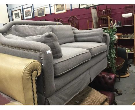 Two-seater sofa upholstered in grey materialCondition report: Good condition, piping damaged on one cushion and stain to corn