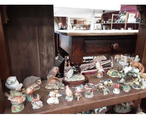 Group of porcelain ornaments including Beswick pheasant, Border Fine Arts Otter group, Royal Worcester blue ties etc