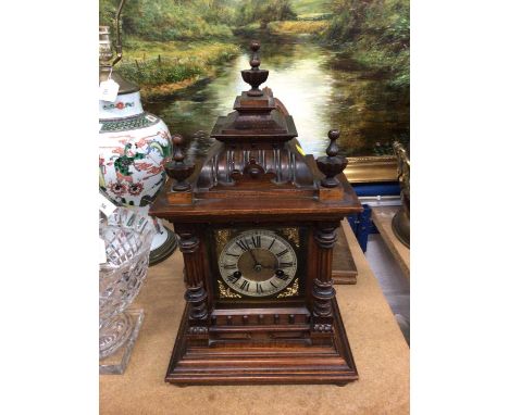 Late 19th century German bracket clock in Gothic wooden case, on later oak bracket