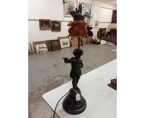 Spelter figural table lamp in the form of a girl playing the flute with amber glass shade