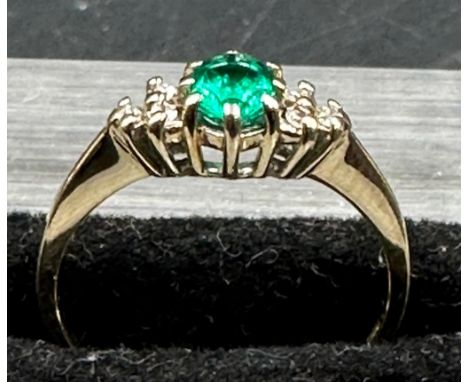 A 9ct gold ring with emerald and diamonds size M