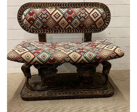 A South African carved bench seat with a kilim style, upholstered and carved birds to back and base 