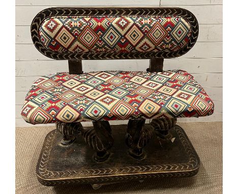 A South African carved bench seat with a Kilim style, upholstered and four carved birds to back and base (H91cm W98cm D44cm S