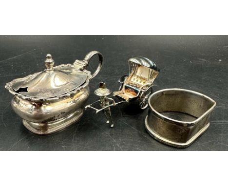 A  hallmarked silver napkin ring and cruet along with a sterling silver rickshaw.