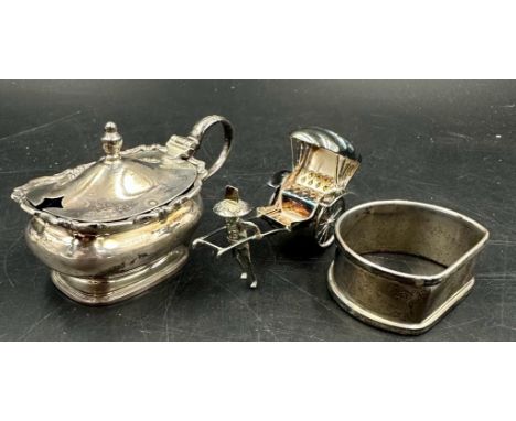 A  hallmarked silver napkin ring and cruet along with a sterling silver rickshaw.