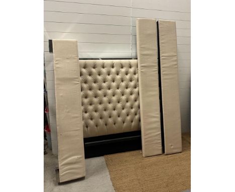 A king size bed with white button backed head board