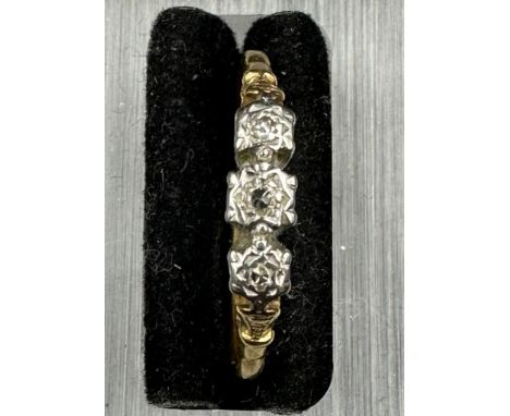 An 18ct gold and platinum three stone diamond ring. Approximate total weight 2.4g Size T 1/2