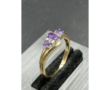 An amethyst and diamond ring, central oval cut amethyst weighing an estimated 0.16ct with three single cut diamonds each side