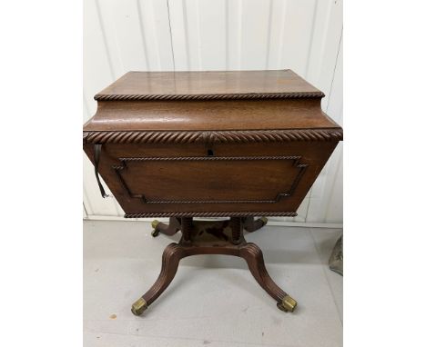 A Regency style Cellarette. The Mahogany caddy opening to compartments and panelled front. Terminating on four reeded legs wi