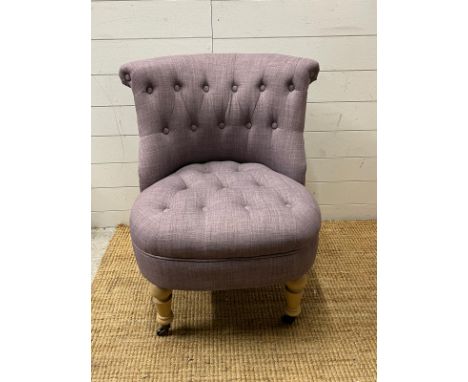 A button back bedroom chair in lilac upholstery 