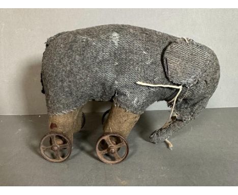 A vintage grey toy elephant on wheels 