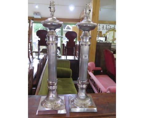 A pair of silver plated table lamps with reeded columns - fitted with  safety lamp holders - Height 61 cm 