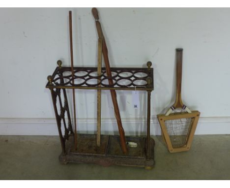 A cast iron hall stand/stick stand - twelve circular compartments with two trays below - Height 64 cm x Width 61 cm x Depth 2