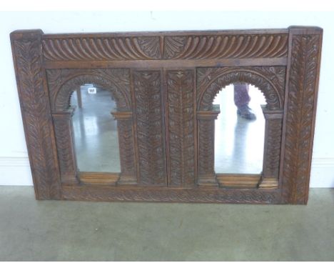 An antique carved oak panel with later mirrored inserts -   Height 74cm x 1.18 m