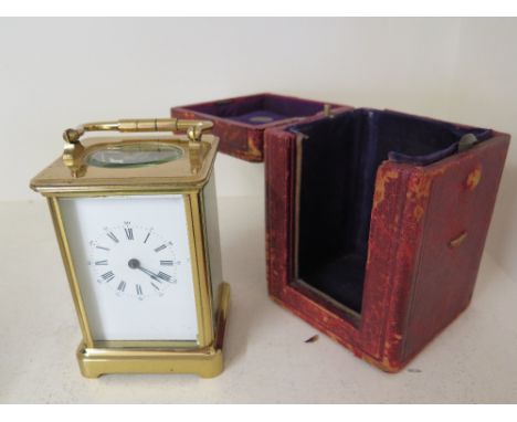 A good quality brass carriage clock striking on a gong the back plate signed Aiguilles - Height 14cm - with original key and 