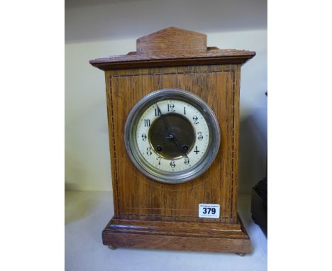 An eight day oak case with inlay mantel clock - strikes hours and half hours on gong
Condition report: Working with key
