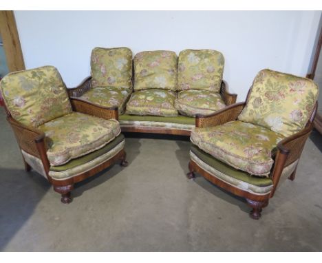 An early 20th century walnut Bergere three piece suite with floral decorated cushions - Settee width 1.73 m x Depth 83 cm x H