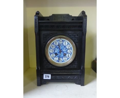 A French eight day mantel clock by Japy Frier - the ebonised case carved decoration, ceramic dial painted with flowers
Condit
