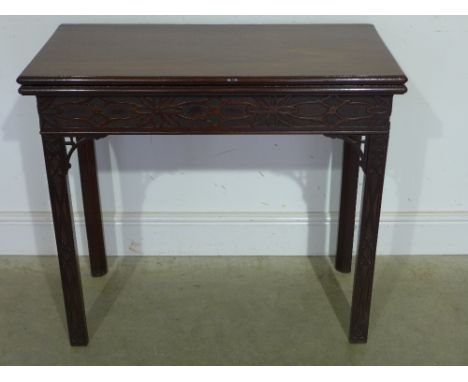 A 19th century mahogany Chippendale style fold over card table with blind fretwork decoration - Width 83 cm 