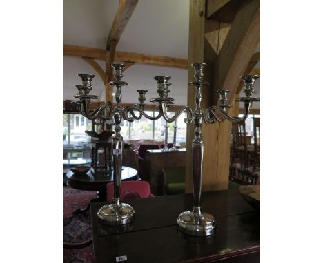 A pair of five light nickel plated candelabra on circular bases - Height 62 cm