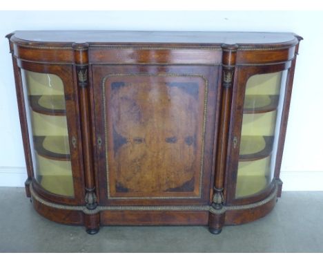 A Victorian walnut side cabinet with a central door flanked either side by bow glazed doors and columns with ormolu mounts - 