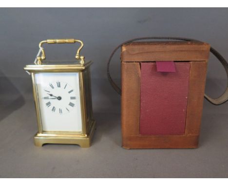 An early 20th century brass cased Carriage clock, white enamel face with Roman numerals, back plate stamped France - in origi