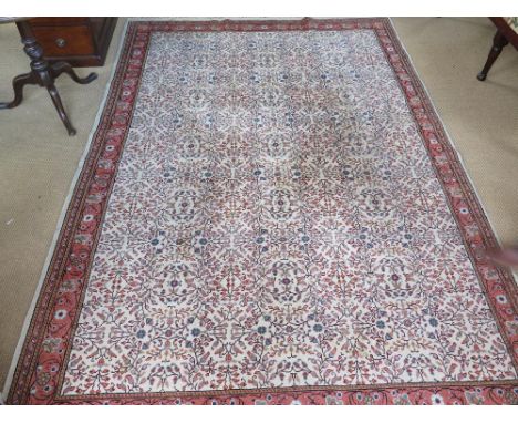 A hand knotted Eastern rug with a cream field - 3.1 m x 2 m
