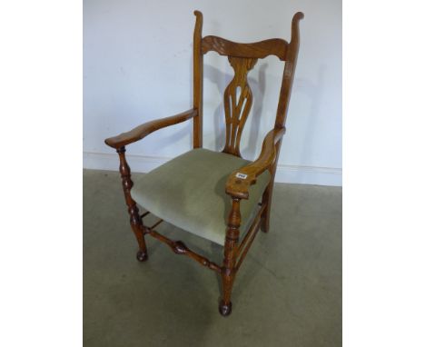A light oak armchair with upholstered seat