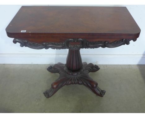 A good quality 19th century mahogany card table on a turned and carved base