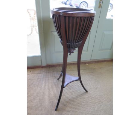 A mahogany basket shaped plant stand with brass liner raised on splayed tripartite base with shelf below - Height 95 cm x Dia